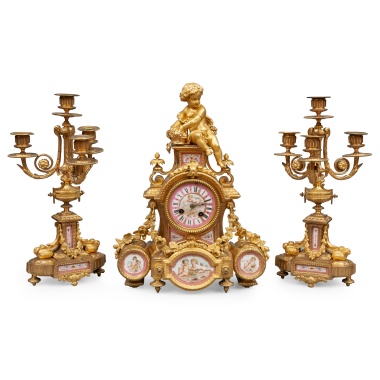 Часы с фигурой амура и два канделябра с фарфоровыми живописными вставками